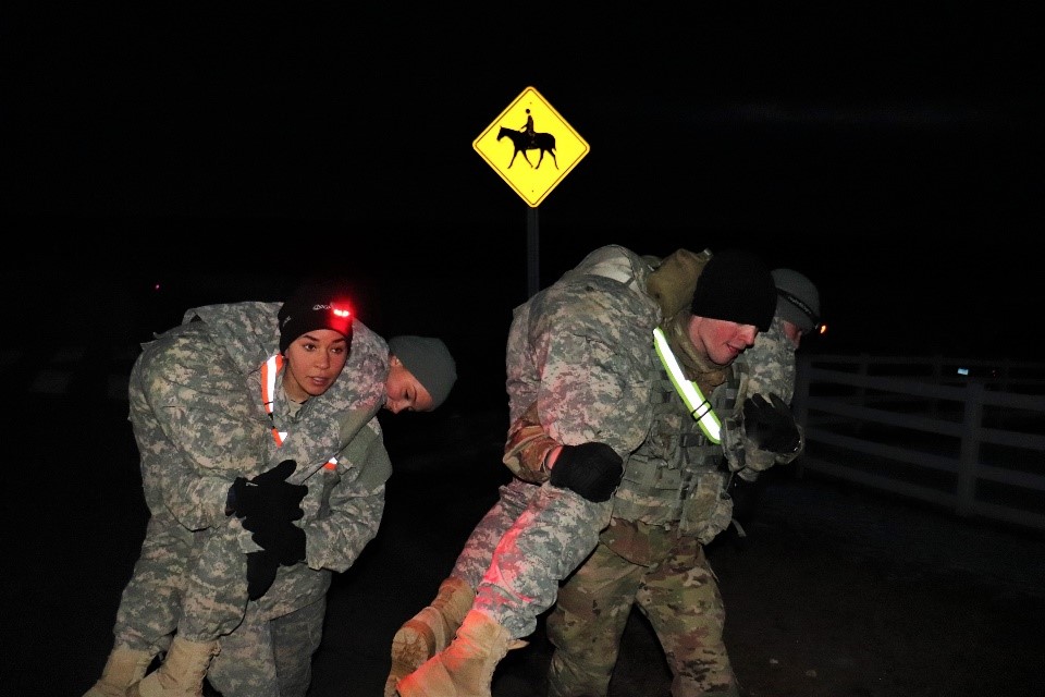 Cadets De La Cruz and McKenna buddy carry their teammates during the culminating event