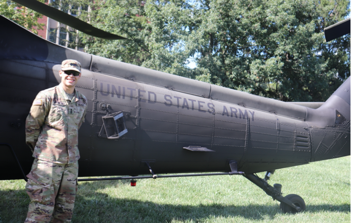 Cadet in front of a Blackhawk helicopter