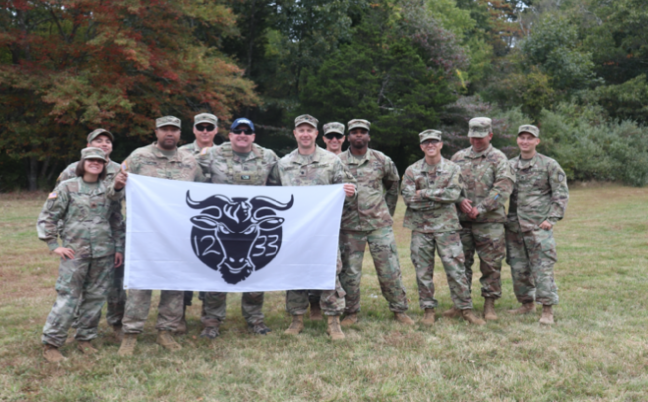 CPT Christopher Young and his Soldiers from MAT 1233 pose for a photo with the PMS and SMI, LTC Christopher Morris and MSG Christopher Crayton.